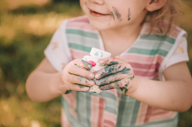 Toddler with paint all over hands