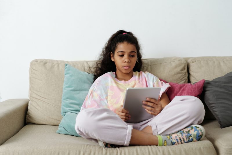 An anxious girl reading something on an iPad