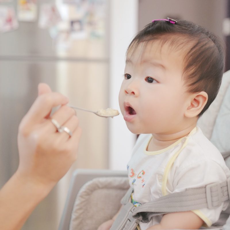 A baby being fed with a spoon