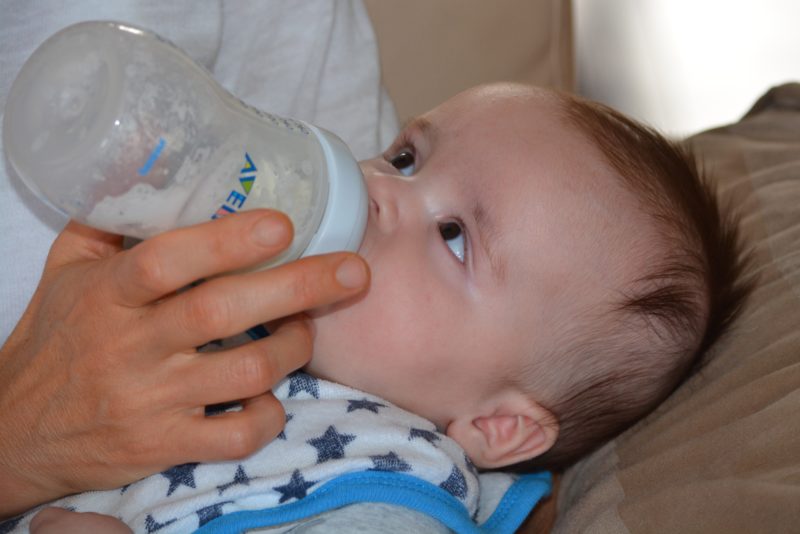 A baby being fed with a bottle